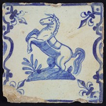 Animal tile, rearing horse to the left on plot between balusters, in blue on white, corner pattern french lily, wall tile