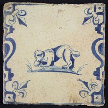 Animal tile, burrowing dog to the left on plot between balusters, in blue on white, corner pattern French lily, wall tile