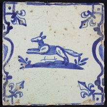 Animal tile, spinning fox left on ground between balusters, in blue on white, corner pattern french lily, wall tile