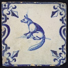 Animal tile, sitting fox to the left on ground between balusters, in blue on white, corner pattern french lily, wall tile