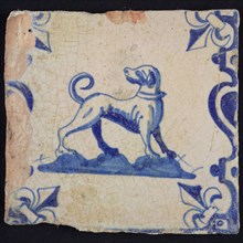 Animal tile, looking back standing dog on the right on ground between balusters, in blue on white, corner pattern french lily