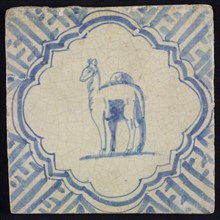 Animal tile, standing dromedary to the left inside scalloped frame with braces, in blue on white, corner motif meanders, wall