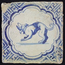 Animal tile, barking dog to the left inside scalloped frame with braces, in blue on white, corner motif meanders, wall tile