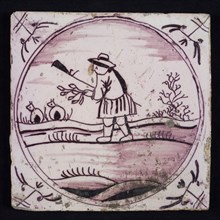 Scene tile, purple with scene decoration with shepherd with branch and staff, in circle frame with corner motifs ox head, wall