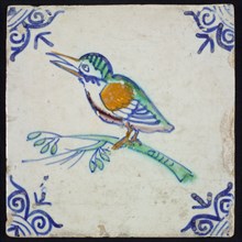 Animal tile, bird on branch to the left in orange, green, purple and blue on white, corner pattern ossenkop, wall tile