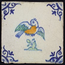 Animal tile, flying bird to the right in orange, green and blue on white, corner pattern ox head, wall tile tile sculpture