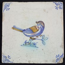 Animal tile, bird on branch to the right in yellow, purple, green and blue on white, corner pattern ox head, wall tile