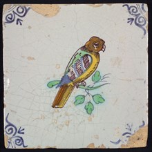 Animal tile, bird on branch to the right in yellow, purple, brown, green and blue on white, corner pattern ox head, wall tile