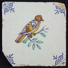 Animal tile, bird on branch to the right in yellow, purple, brown, green and blue on white, corner pattern ossenkop, wall tile