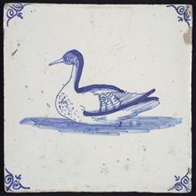 Animal tile, swimming bird in water to the left, in blue on white, corner motif oxen head, wall tile tile sculpture ceramic