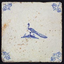 Animal tile, bird on ground to the left, in blue on white, corner motif ox's head, wall tile tile sculpture ceramic earthenware