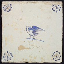 Animal tile, standing bird with curved head under the wing to the left, in purple and blue on white, corner motif spider, wall