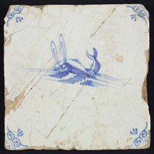 Animal tile, water-spouting dolphin in water to the left, in blue on white, corner motif, ox-head, wall tile tile sculpture