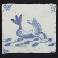 Animal tile, marine in continuous water to the right, in blue on white, corner motif of ox's head, wall tile tile sculpture