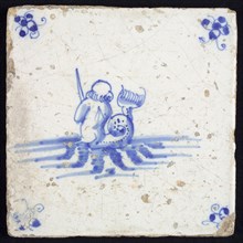 Sea creature tile, in blue on white, on the back seen naked man with fish tail in water to the right, in hand sword, corner
