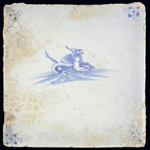 Sea creature tile, in blue on white, dragon-like creature with wings and pintail in water to the right, corner pattern spider