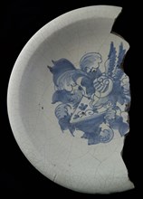 Fragment majolica dish, blue on white, with heraldic image, helmeted escutcheon with diagonal division, above dark, under light