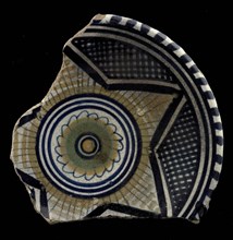 Fragment of the majolica dish, polychrome, in the middle rosette, outside of that star motif, plate crockery holder soil find