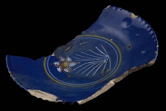 Fragment of saucer dish, dark blue ground, on the mirror polychrome flower (daffodil?), plate crockery holder soil find ceramic