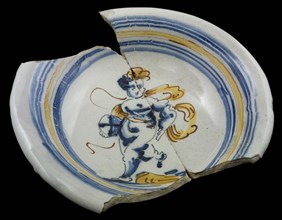 Fragments of faience plate, polychrome putto with ball, on the edge concentric circles, plate dish crockery holder soil find