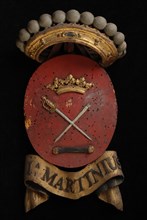 Carved wooden crowned coat of arms including the name Ia. Martinius, coat of arms information form wood carving sculpture