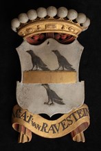 Carved wooden crowned coat of arms including the name Mr. .I. Van Ravestein, coat of arms informative form carvings sculpture