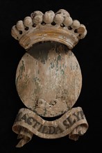 Carved wooden crowned coat of arms including the name Magtilda Slyp, escutcheon information form woodcarving sculpture imagery