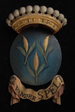 Carved wooden crowned coat of arms including the name G. Van der Spelt, with fragment that has been demolished on which part of