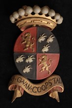 Carved wooden crowned coat of arms including the name M.G. van Coopstad, coat of arms information form carvings sculpture
