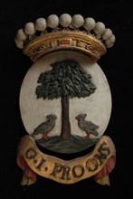 Carved wooden crowned coat of arms including the name G.I. Proons, coat of arms information form wood carving sculpture