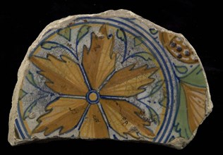 Fragment majolica plate, yellow, orange, green, purple and blue on white, six stylized leaves on mirror, pomegranates in the