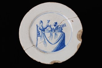 Faience plate on stand, blue on white, man with raised glass on covered table, plate crockery holder soil find ceramic