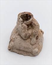 Part of pipe image, representing cushion with sitting figure, sculpture visual material soil finds clay, in mold formed baked
