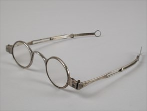 Glasses with oval lenses on strength, silver frame and adjustable straight feathers, spectacle eye lens equipment glass metal