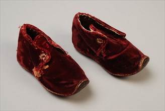 Dark red velvet baby shoes with leather sole that curls up at the pointed nose, lacing, shoe footwear baby clothing children's