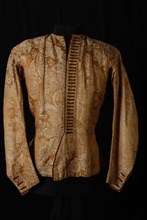 Mens vest made of gold-beige half-silk damask or brocade with pattern of flowers and arabesques finished with brown cord
