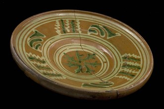 Red earthenware plate or dish with yellow and green decoration in sludge technology, plate dish crockery holder soil find