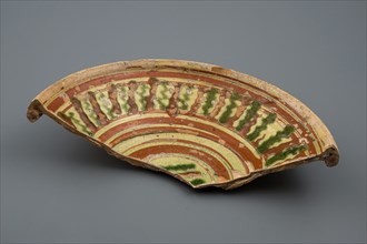 Fragment earthenware dish with green and brown silt decoration on yellow ground, plate dish crockery holder soil find ceramic