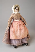 mw. Andres-Van Embden, Dollhouse doll, papier-mâché head with inlaid brown glass eyes, wooden forearms, fabric body and legs