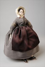 mw. Andres-Van Embden, Dollhouse doll, papier-mâché head with inlaid brown glass eyes, wooden forearms, fabric body and legs