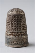 Silver thimble with pattern of pits, along the bottom edge of the inscription Catalina Blavoet 1595, thimble sewing kit soil