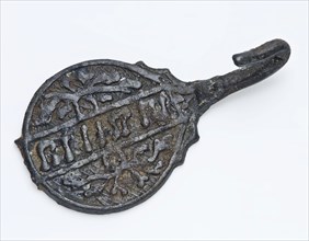 Belted tongue with round decorated disk, ending in hook, frieze with text on the disk, belt clothing accessory clothing soil