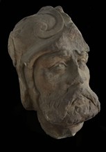 Stone head of warrior with mustache, beard and helmet, sculpture footage fragment sandstone stone lead iron, sculpted Sandstone