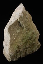 Building fragment of beige-gray natural stone, originating from tower or wall that was originally connected to the Schiedam Gate