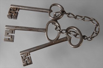 Bunch of keys: three iron keys with solid key stems and cruciform beards in beard, connected by means of an iron chain, key