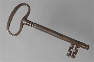 Iron key with elongated eye, solid key handle and cruciform beards in beard, key iron commodity founding iron, hand-forged key