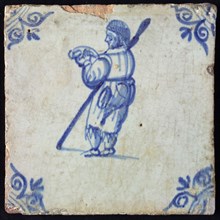 Occupation tile, blue, standing man with staff, Corner motif ox's head, wall tile tile sculpture ceramic earthenware enamel