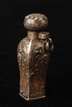 Silver perfume bottle, square model with s-line, rococo ornaments in relief, hanging eye on neck and glass interior, perfume