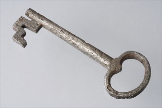 Key with oval handle and beard, key iron commodity founding iron metal, forged archeology closing door theft prevention property