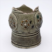 Green foot of cup or mug with three weapon medallions and two rosettes, rad stamp around foot, jug cup drinking utensils